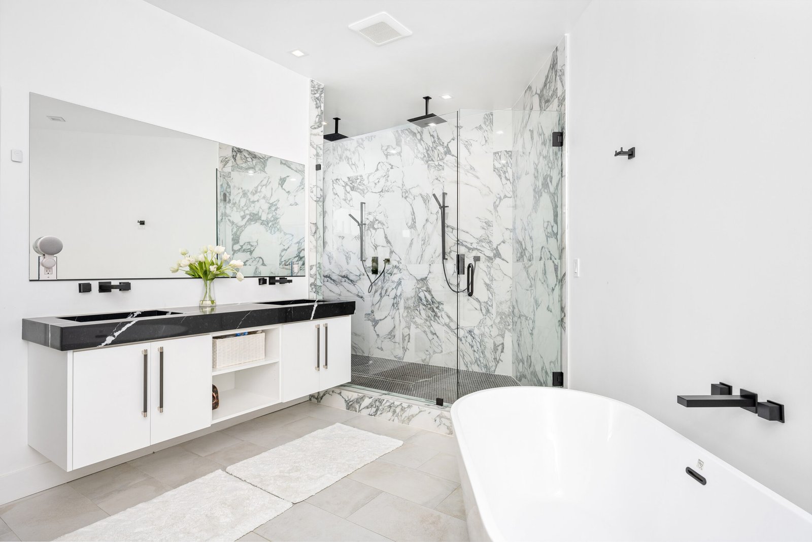 A modern white bathroom with a luxurious marble countertop and a bathtub
