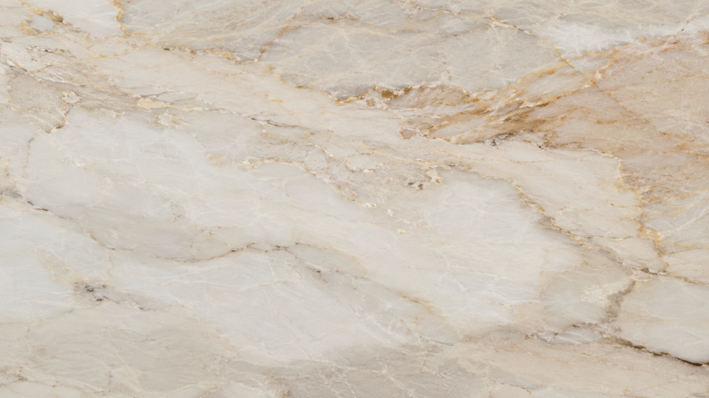 Close-up of Taj Mahal quartzite slab with cream base and soft gold veining